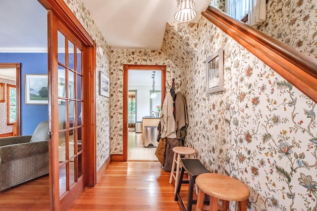 42 Sargent St, Westbrook, ME 04092 - hallway with wallpapered walls, light wood-style flooring, and french doors