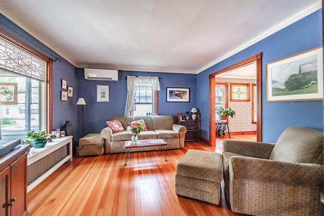 42 Sargent St, Westbrook, ME 04092 - living room featuring a wall unit AC, light wood-style floors, and crown molding