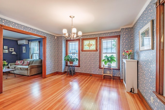 42 Sargent St, Westbrook, ME 04092 - dining area featuring a wall mounted air conditioner, light wood-style floors, a chandelier, ornamental molding, and wallpapered walls