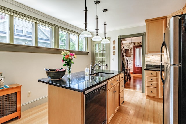 42 Sargent St, Westbrook, ME 04092 - kitchen featuring freestanding refrigerator, black dishwasher, light wood-style flooring, an island with sink, and ornamental molding