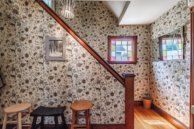 42 Sargent St, Westbrook, ME 04092 - staircase with wood finished floors, healthy amount of natural light, wallpapered walls, and lofted ceiling