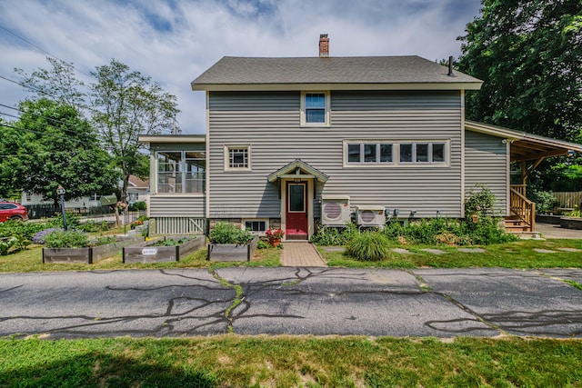 42 Sargent St, Westbrook, ME 04092 - view of front of property with a garden, a chimney, and a sunroom