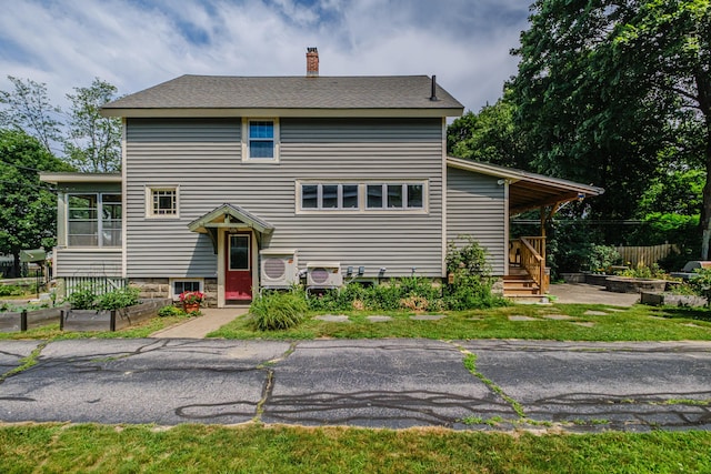 42 Sargent St, Westbrook, ME 04092 - view of front facade featuring a chimney, a vegetable garden, and a sunroom