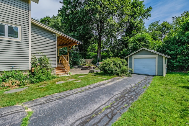 42 Sargent St, Westbrook, ME 04092 - view of grassy yard with a garage, an outdoor structure, and driveway