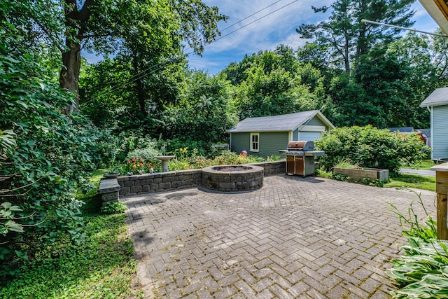 42 Sargent St, Westbrook, ME 04092 - view of patio / terrace with a fire pit, an outdoor structure, and a grill