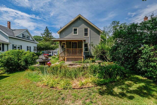42 Sargent St, Westbrook, ME 04092 - rear view of property with a lawn and a porch