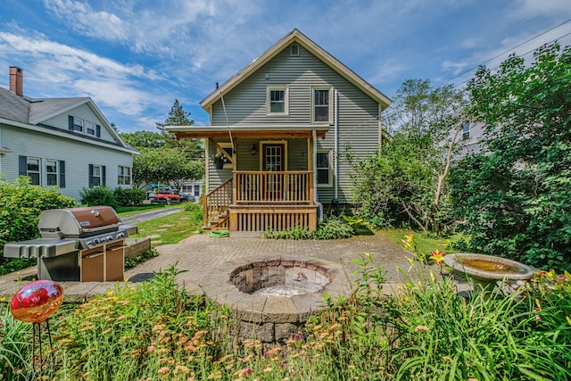 42 Sargent St, Westbrook, ME 04092 - back of property featuring an outdoor fire pit and a porch