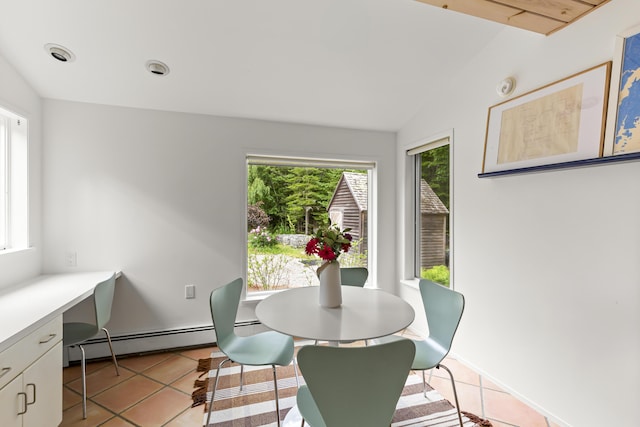133 Scraggle Point Rd, Saint George, ME 04859 - dining room with a baseboard radiator, healthy amount of natural light, light tile patterned floors, an office area, and vaulted ceiling