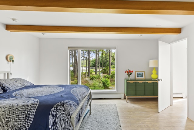 133 Scraggle Point Rd, Saint George, ME 04859 - bedroom with beam ceiling, light wood-style floors, a baseboard radiator, and baseboard heating
