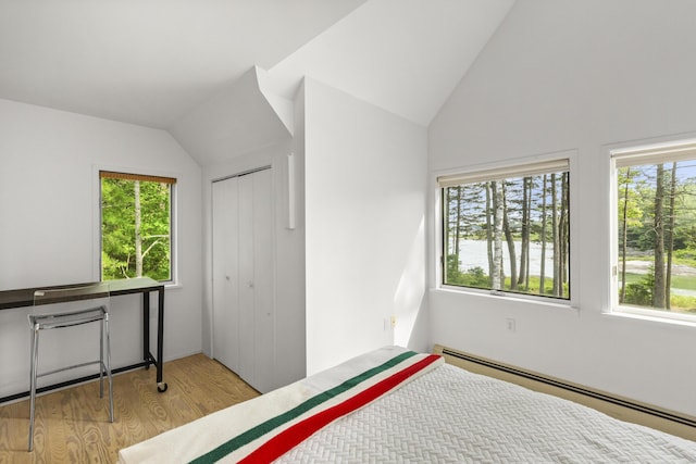 133 Scraggle Point Rd, Saint George, ME 04859 - bedroom with baseboard heating, light wood-style flooring, lofted ceiling, and a closet