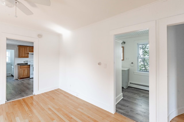19 Fall St, Biddeford, ME 04005 - unfurnished room featuring a baseboard heating unit, light wood-style floors, a ceiling fan, a baseboard radiator, and ornamental molding