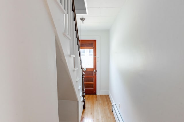 19 Fall St, Biddeford, ME 04005 - hall with light wood-style floors, a baseboard heating unit, and stairway
