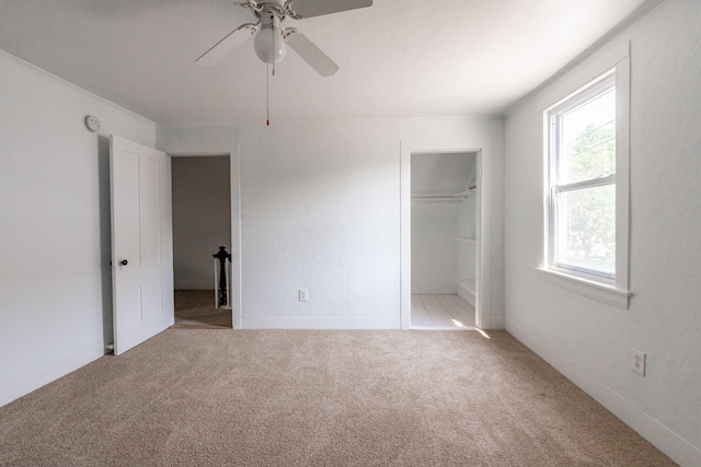 19 Fall St, Biddeford, ME 04005 - unfurnished bedroom featuring light colored carpet, a walk in closet, a closet, and a ceiling fan