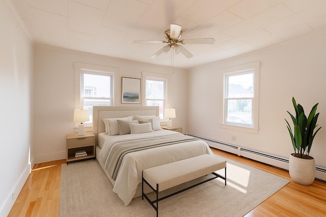 19 Fall St, Biddeford, ME 04005 - bedroom with light wood-style flooring, baseboard heating, and ceiling fan