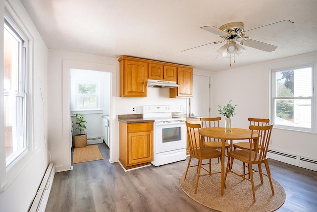 19 Fall St, Biddeford, ME 04005 - kitchen with electric stove, under cabinet range hood, a baseboard radiator, and a ceiling fan