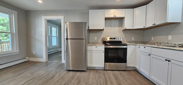 158 Water St, Waterville, ME 04901 - kitchen featuring appliances with stainless steel finishes, a baseboard radiator, light wood finished floors, white cabinetry, and recessed lighting