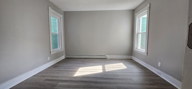 158 Water St, Waterville, ME 04901 - empty room featuring a baseboard heating unit and dark wood-style floors