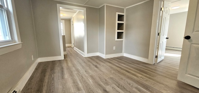 158 Water St, Waterville, ME 04901 - unfurnished room with baseboard heating, ornamental molding, and wood finished floors