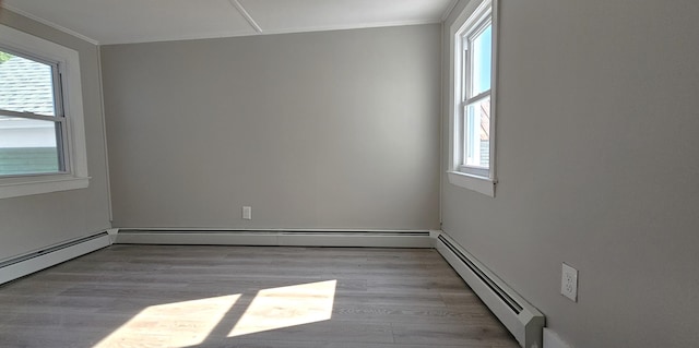 158 Water St, Waterville, ME 04901 - unfurnished room featuring a baseboard radiator, plenty of natural light, crown molding, and wood finished floors
