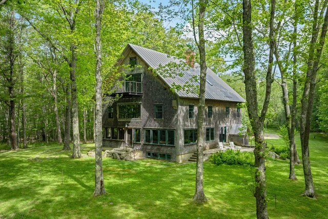 372 Bald Head Rd, Arrowsic, ME 04530 - view of front of home featuring a balcony, a front lawn, and a chimney
