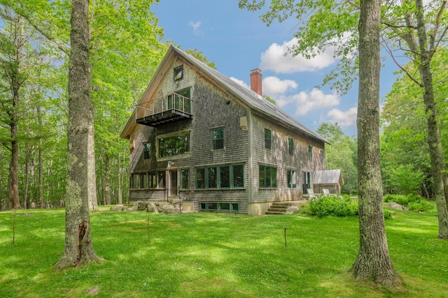 372 Bald Head Rd, Arrowsic, ME 04530 - back of property with a balcony, a chimney, and a lawn