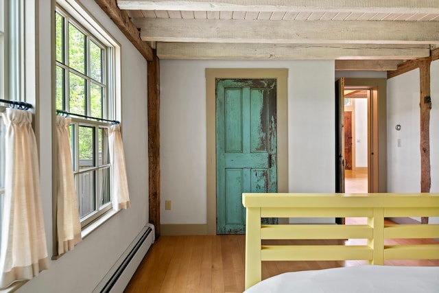 372 Bald Head Rd, Arrowsic, ME 04530 - bedroom with beamed ceiling, baseboard heating, and light wood-style flooring