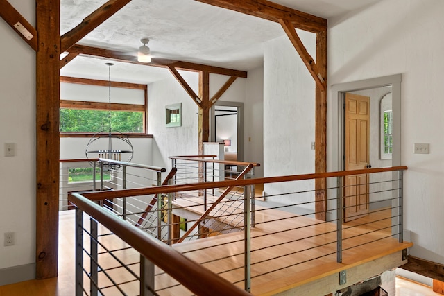 372 Bald Head Rd, Arrowsic, ME 04530 - corridor featuring an upstairs landing, healthy amount of natural light, a chandelier, beam ceiling, and wood finished floors
