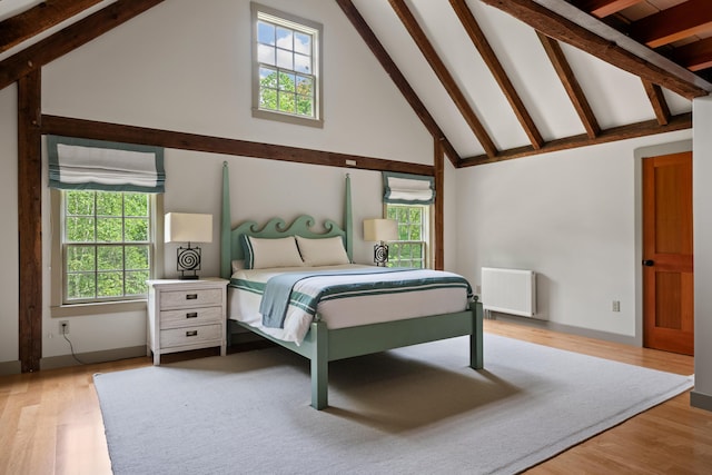 372 Bald Head Rd, Arrowsic, ME 04530 - bedroom with radiator, beam ceiling, high vaulted ceiling, and wood finished floors