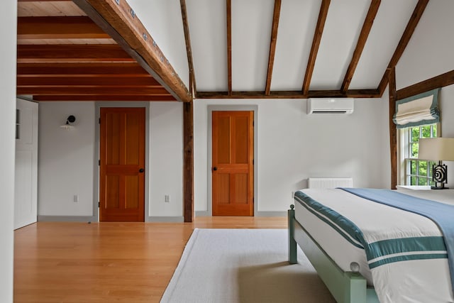 372 Bald Head Rd, Arrowsic, ME 04530 - bedroom with a wall mounted AC and wood finished floors