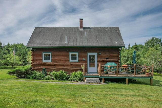 15 Tranquility Way, Ellsworth, ME 04605 - back of property with log siding, a yard, a wooden deck, a chimney, and a shingled roof