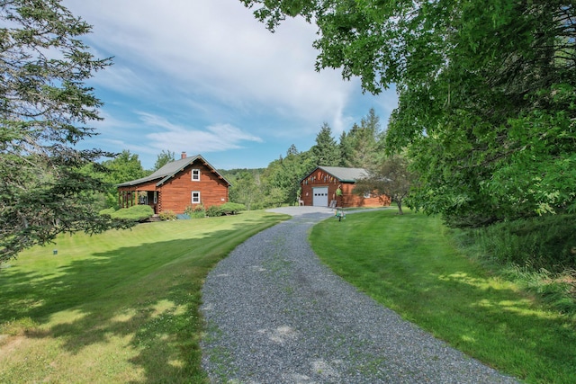 15 Tranquility Way, Ellsworth, ME 04605 - view of front of property featuring an outdoor structure, gravel driveway, a front yard, and a chimney