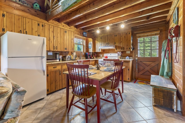 15 Tranquility Way, Ellsworth, ME 04605 - kitchen featuring white appliances, healthy amount of natural light, light countertops, wood walls, and brown cabinets