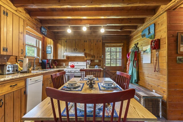 15 Tranquility Way, Ellsworth, ME 04605 - kitchen with white appliances, extractor fan, wooden walls, brown cabinets, and a wooden ceiling with exposed beams