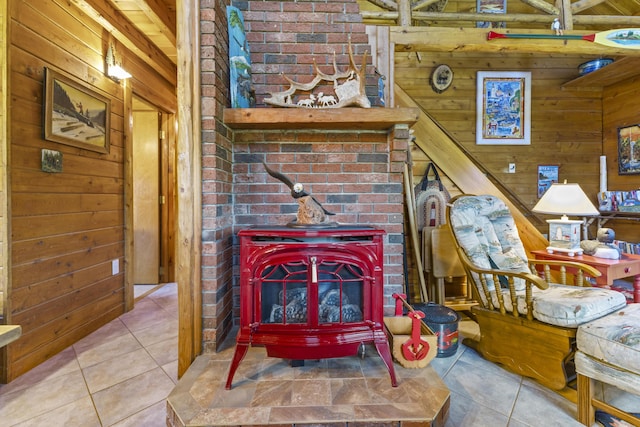 15 Tranquility Way, Ellsworth, ME 04605 - tiled living room with a wood stove and wood walls