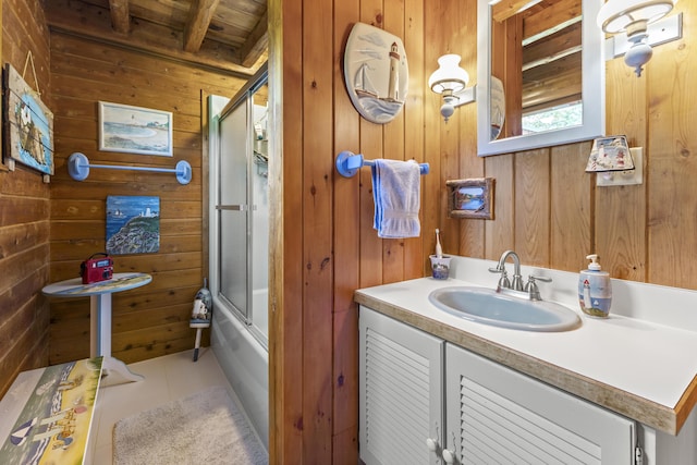 15 Tranquility Way, Ellsworth, ME 04605 - full bath featuring wood walls, vanity, wooden ceiling, tile patterned flooring, and shower / bath combination with glass door