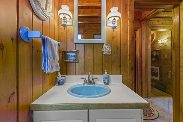 15 Tranquility Way, Ellsworth, ME 04605 - bathroom featuring vanity, wood walls, and tile patterned floors