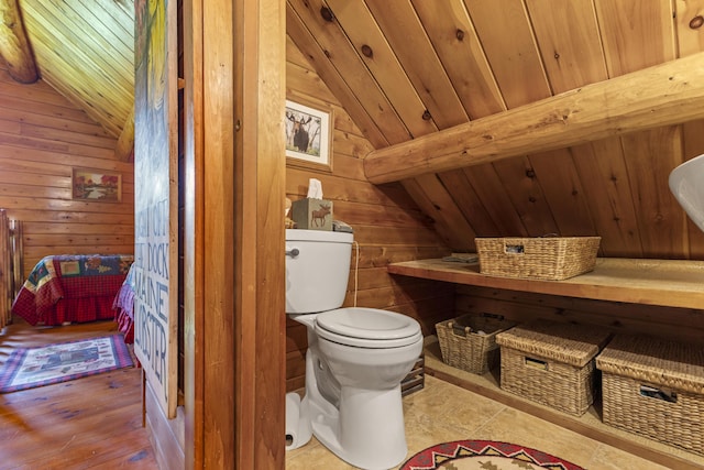 15 Tranquility Way, Ellsworth, ME 04605 - bathroom featuring lofted ceiling, wooden walls, wooden ceiling, and wood finished floors