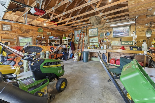 15 Tranquility Way, Ellsworth, ME 04605 - garage with a workshop area, a garage door opener, and wood walls