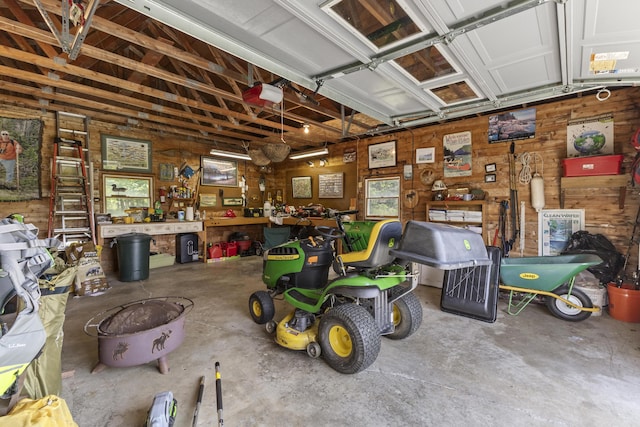 15 Tranquility Way, Ellsworth, ME 04605 - garage featuring a workshop area and wooden walls