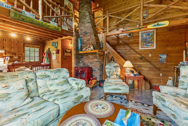 15 Tranquility Way, Ellsworth, ME 04605 - living area featuring wood walls, a wood stove, and high vaulted ceiling
