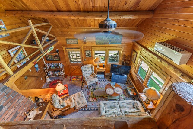 15 Tranquility Way, Ellsworth, ME 04605 - living area with a wooden ceiling with exposed beams, wood walls, and an AC wall unit