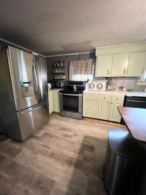 20 Coles Corner Rd, Winterport, ME 04496 - kitchen featuring appliances with stainless steel finishes, light wood-style flooring, decorative backsplash, and light countertops