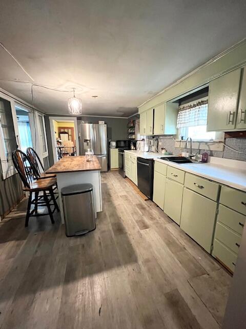 20 Coles Corner Rd, Winterport, ME 04496 - kitchen featuring stainless steel fridge with ice dispenser, black dishwasher, light wood-type flooring, butcher block counters, and a center island