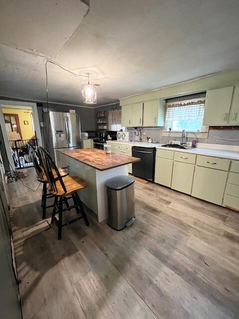 20 Coles Corner Rd, Winterport, ME 04496 - kitchen featuring black dishwasher, butcher block counters, stainless steel refrigerator with ice dispenser, light wood-style flooring, and a center island