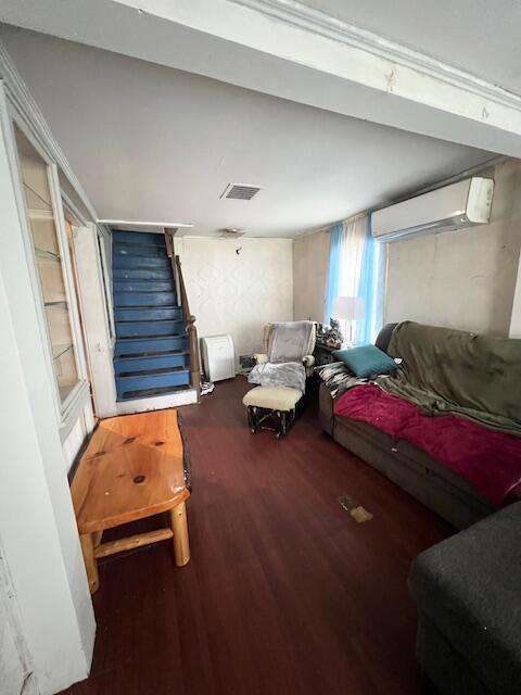 20 Coles Corner Rd, Winterport, ME 04496 - living area with a wall unit AC, wood finished floors, and stairway