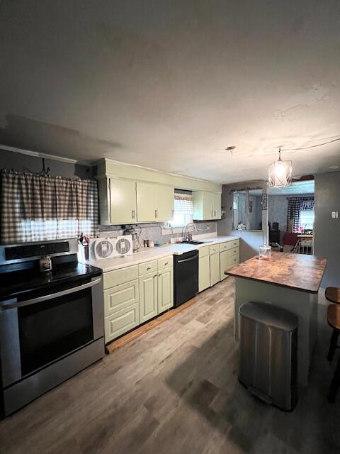 20 Coles Corner Rd, Winterport, ME 04496 - kitchen featuring stainless steel electric stove, black dishwasher, wood finished floors, and decorative backsplash