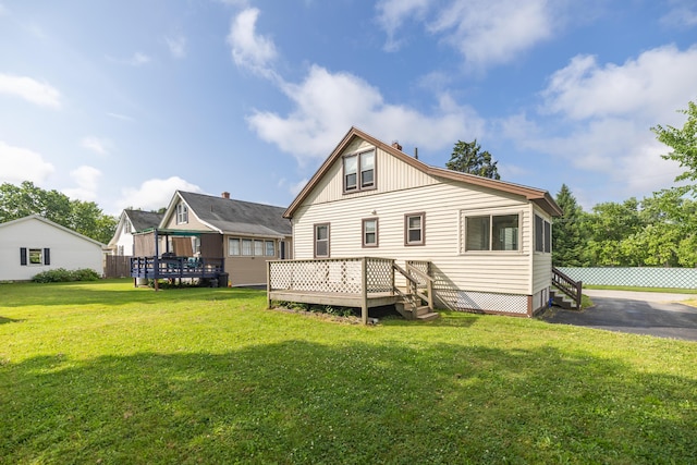2 Tucker St, Lewiston, ME 04240 - rear view of property with a deck and a lawn