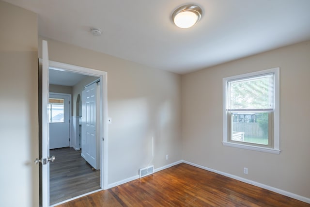 2 Tucker St, Lewiston, ME 04240 - unfurnished room with plenty of natural light, dark wood-style flooring, and a smoke detector