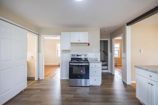 2 Tucker St, Lewiston, ME 04240 - kitchen featuring stainless steel electric range, dark wood-style floors, plenty of natural light, and white cabinetry
