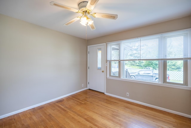 2 Tucker St, Lewiston, ME 04240 - empty room with light wood-style flooring and a ceiling fan